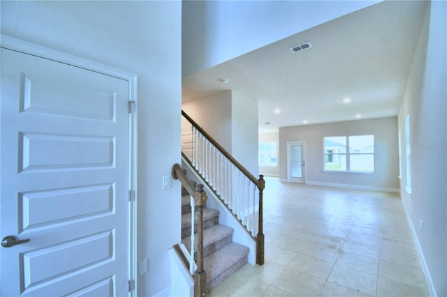 stairs featuring light tile floors