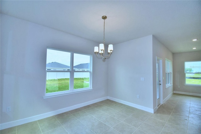 tiled empty room featuring an inviting chandelier