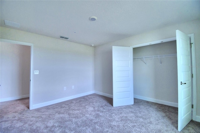 unfurnished bedroom with a closet and carpet floors