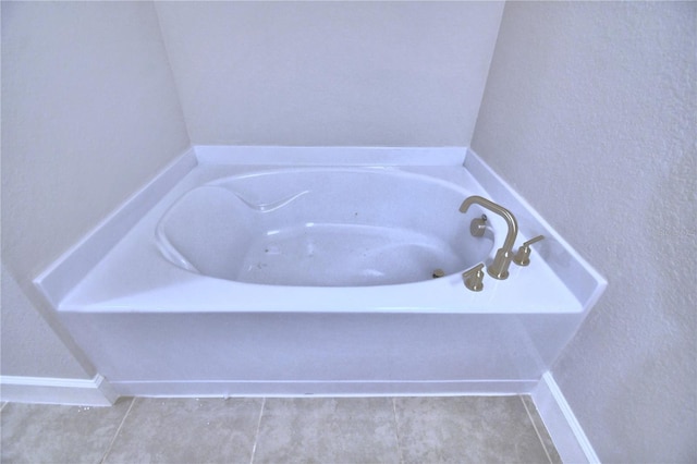 bathroom featuring a bathtub and tile flooring