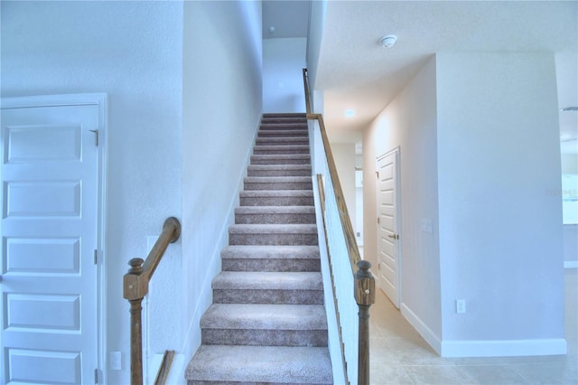 stairway with light tile floors