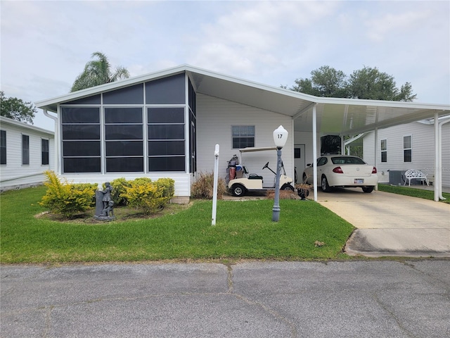 view of front facade with a front yard and a carport