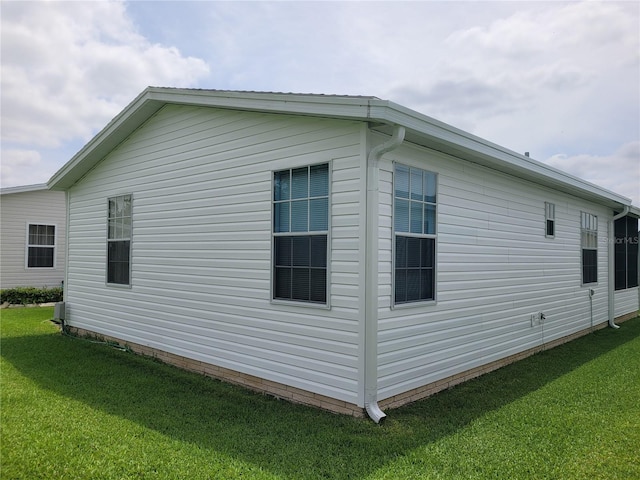 view of home's exterior with a lawn