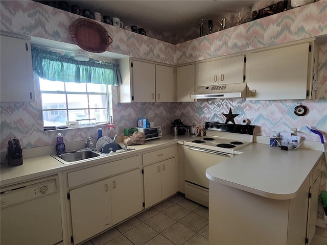 kitchen featuring white appliances, backsplash, light tile floors, sink, and kitchen peninsula