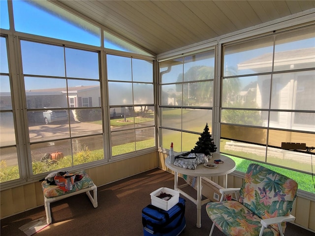 sunroom featuring wooden ceiling and lofted ceiling