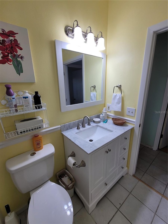 bathroom featuring tile floors, toilet, and vanity