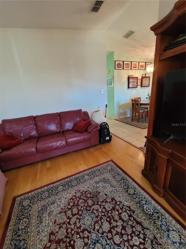 living room with lofted ceiling and tile flooring