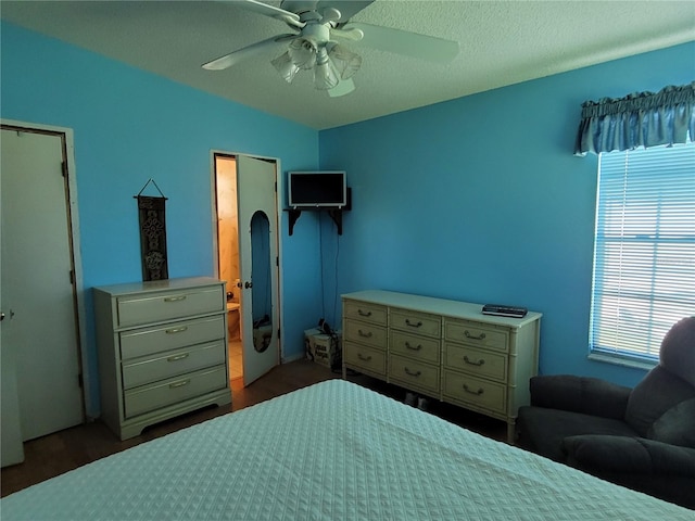 bedroom with a textured ceiling and ceiling fan