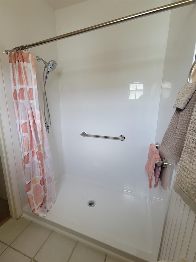 bathroom with a shower with curtain and tile floors