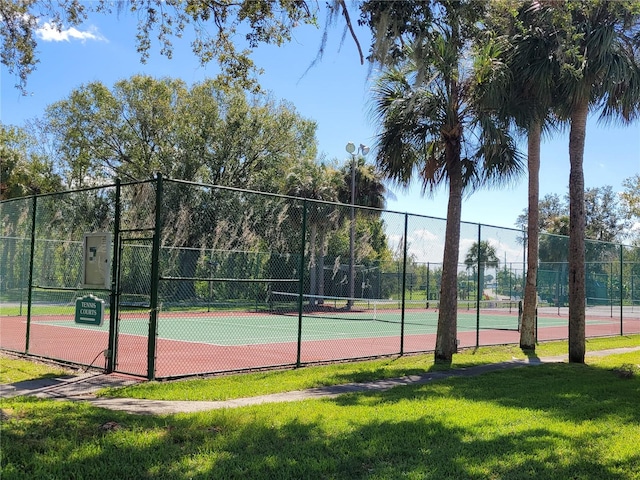 view of sport court with a yard