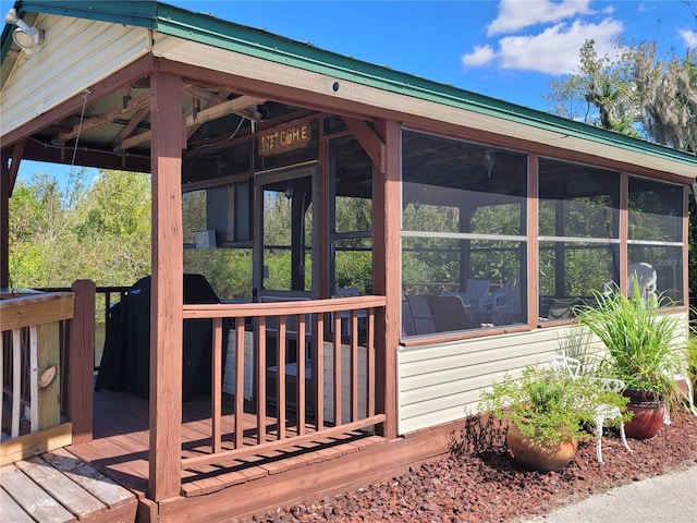 view of side of property featuring a deck and a sunroom