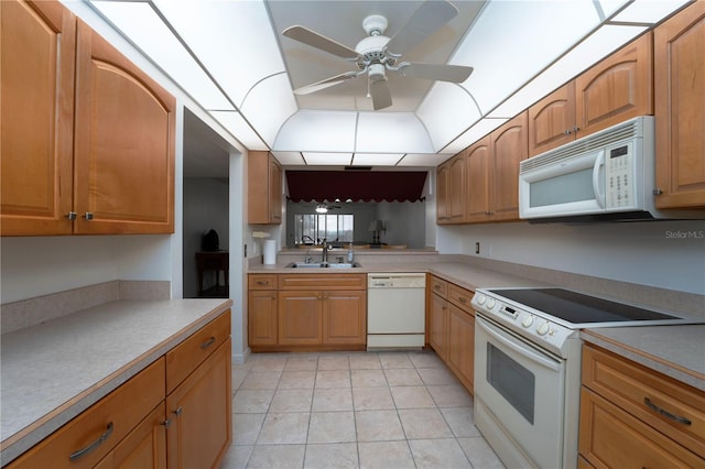 kitchen with white appliances, ceiling fan, sink, and light tile floors