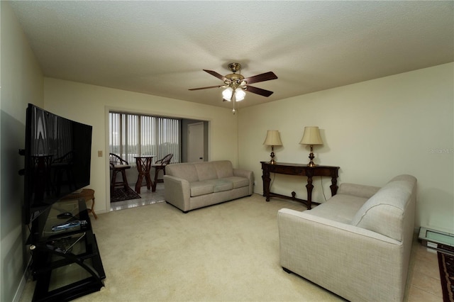 tiled living room with a textured ceiling and ceiling fan