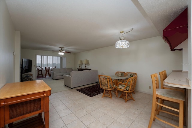 tiled living room with ceiling fan