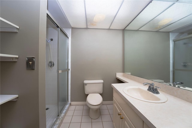 bathroom with oversized vanity, an enclosed shower, tile floors, and toilet