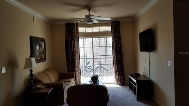 living area featuring carpet floors, ceiling fan, and ornamental molding