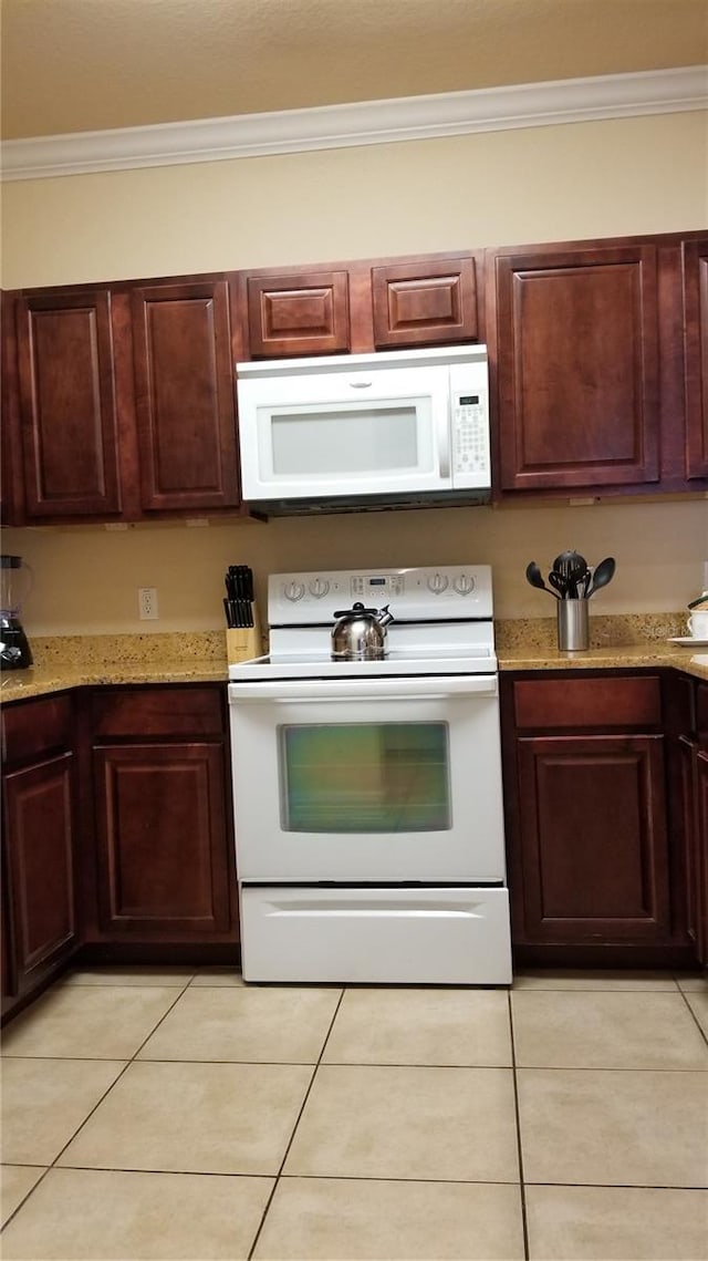 kitchen featuring white appliances, light stone countertops, crown molding, and light tile floors