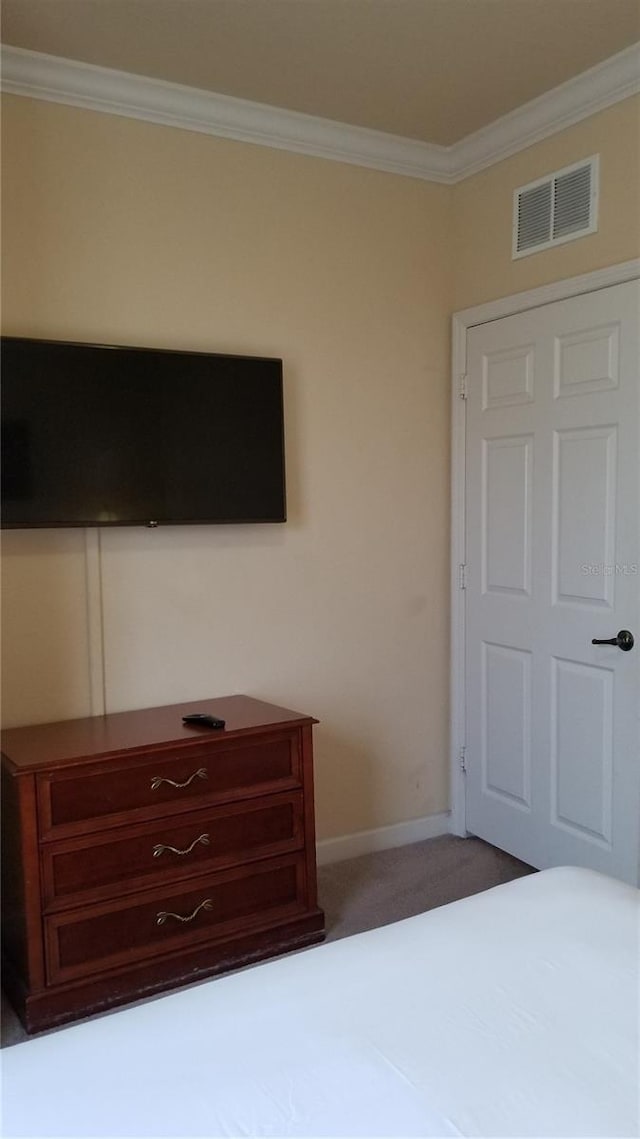 unfurnished bedroom featuring ornamental molding and dark colored carpet