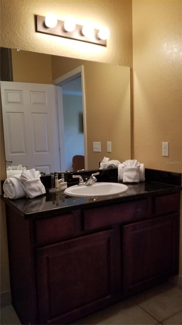 bathroom featuring tile floors and vanity