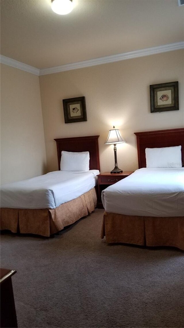 carpeted bedroom featuring ornamental molding