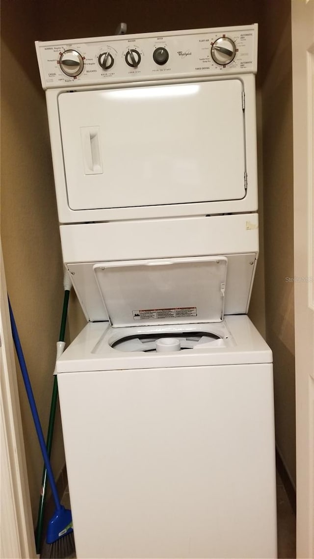 washroom featuring stacked washer and clothes dryer