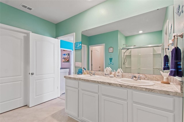 bathroom with tile patterned floors, vanity, and a shower with shower door