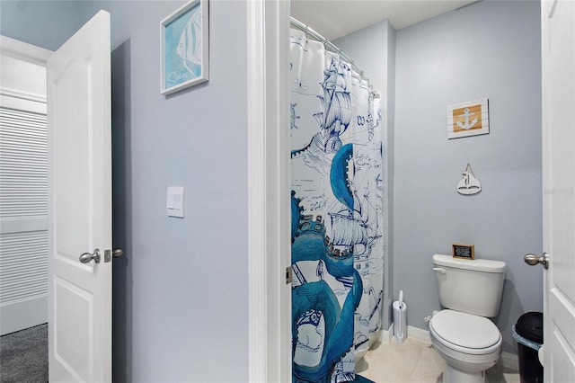 bathroom with tile patterned flooring, toilet, and walk in shower