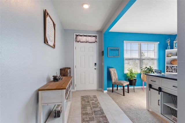 foyer with light colored carpet