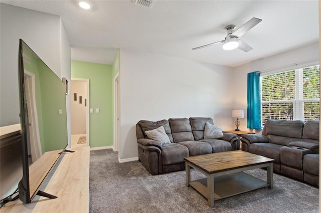 living room featuring carpet flooring and ceiling fan