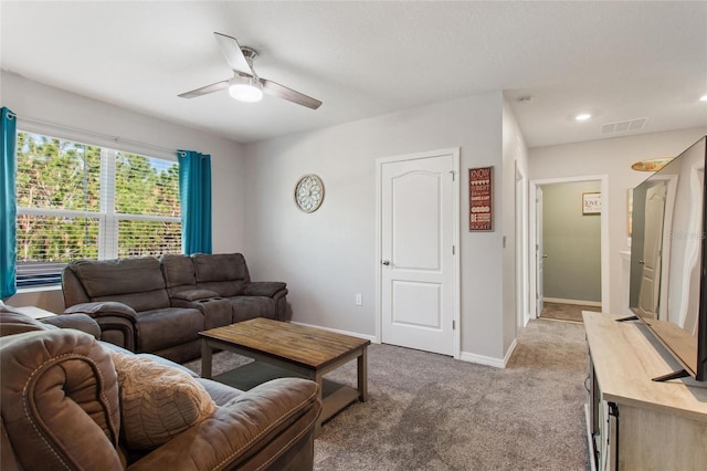 living room featuring ceiling fan and light carpet