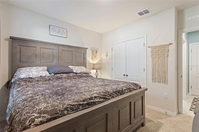 bedroom with light colored carpet and a closet