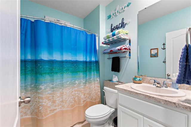 bathroom with vanity, toilet, and curtained shower