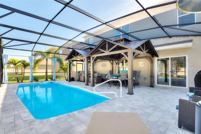 view of swimming pool featuring a patio, glass enclosure, and an outdoor hangout area