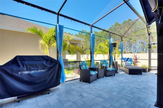 view of patio featuring a lanai, grilling area, and an outdoor hangout area