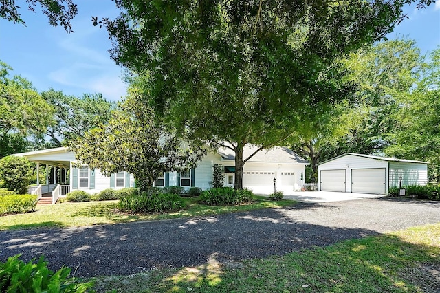 view of front of house featuring a garage and an outdoor structure