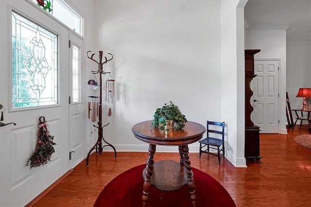 entrance foyer featuring wood-type flooring and ornamental molding