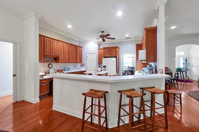 kitchen featuring ceiling fan, tasteful backsplash, hardwood / wood-style floors, ornamental molding, and white appliances