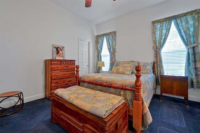 bedroom featuring ceiling fan and dark carpet