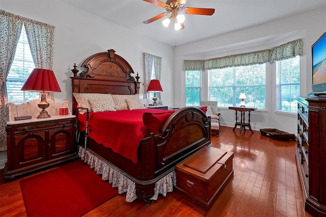 bedroom with dark hardwood / wood-style floors and ceiling fan