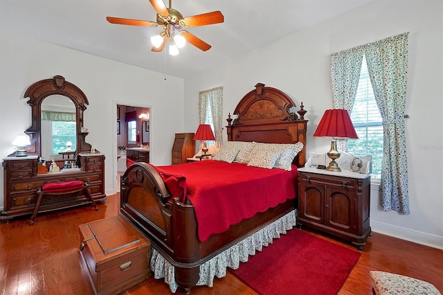 bedroom featuring hardwood / wood-style floors, connected bathroom, and ceiling fan