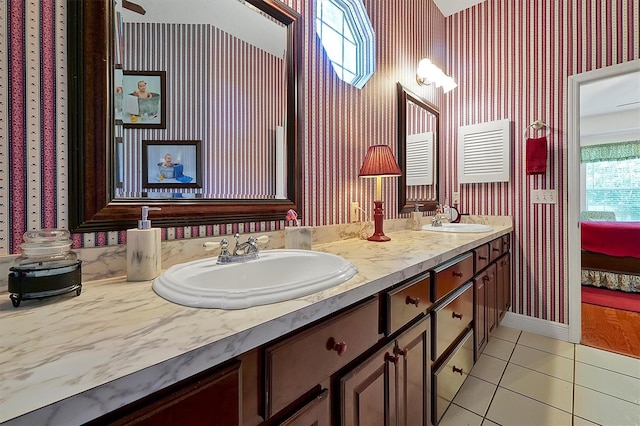 bathroom with dual bowl vanity and tile flooring