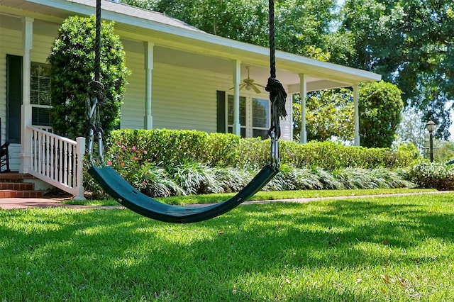 view of home's exterior featuring a lawn and ceiling fan