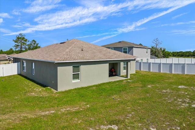 rear view of property with a yard