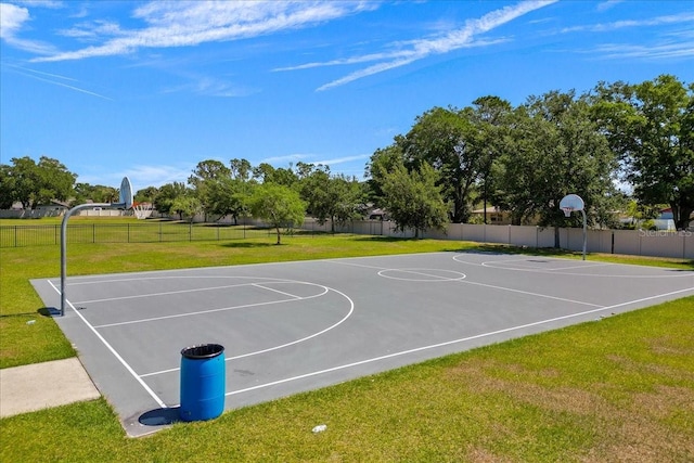 view of sport court with a yard