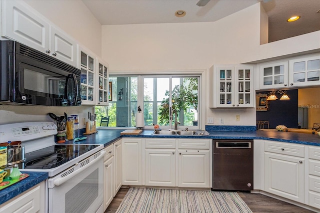 kitchen featuring wood-type flooring, sink, white cabinets, dishwashing machine, and white range with electric cooktop