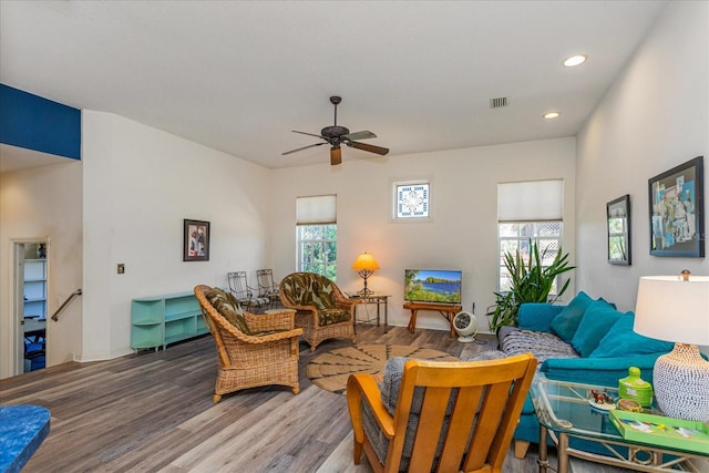 living room with wood-type flooring and ceiling fan