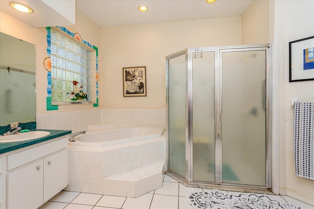 bathroom featuring tile patterned flooring, vanity, and separate shower and tub