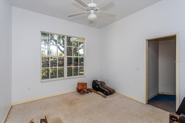 spare room with ceiling fan, dark carpet, and a healthy amount of sunlight