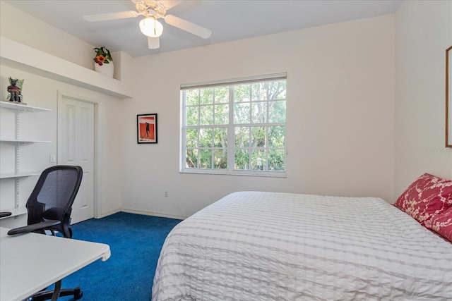 bedroom with ceiling fan and dark colored carpet