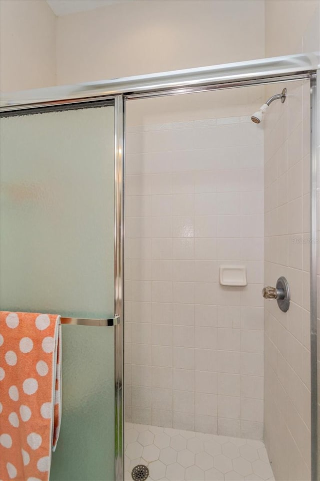 bathroom with a shower with door